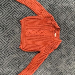 A cute, red knitted crop sweater
